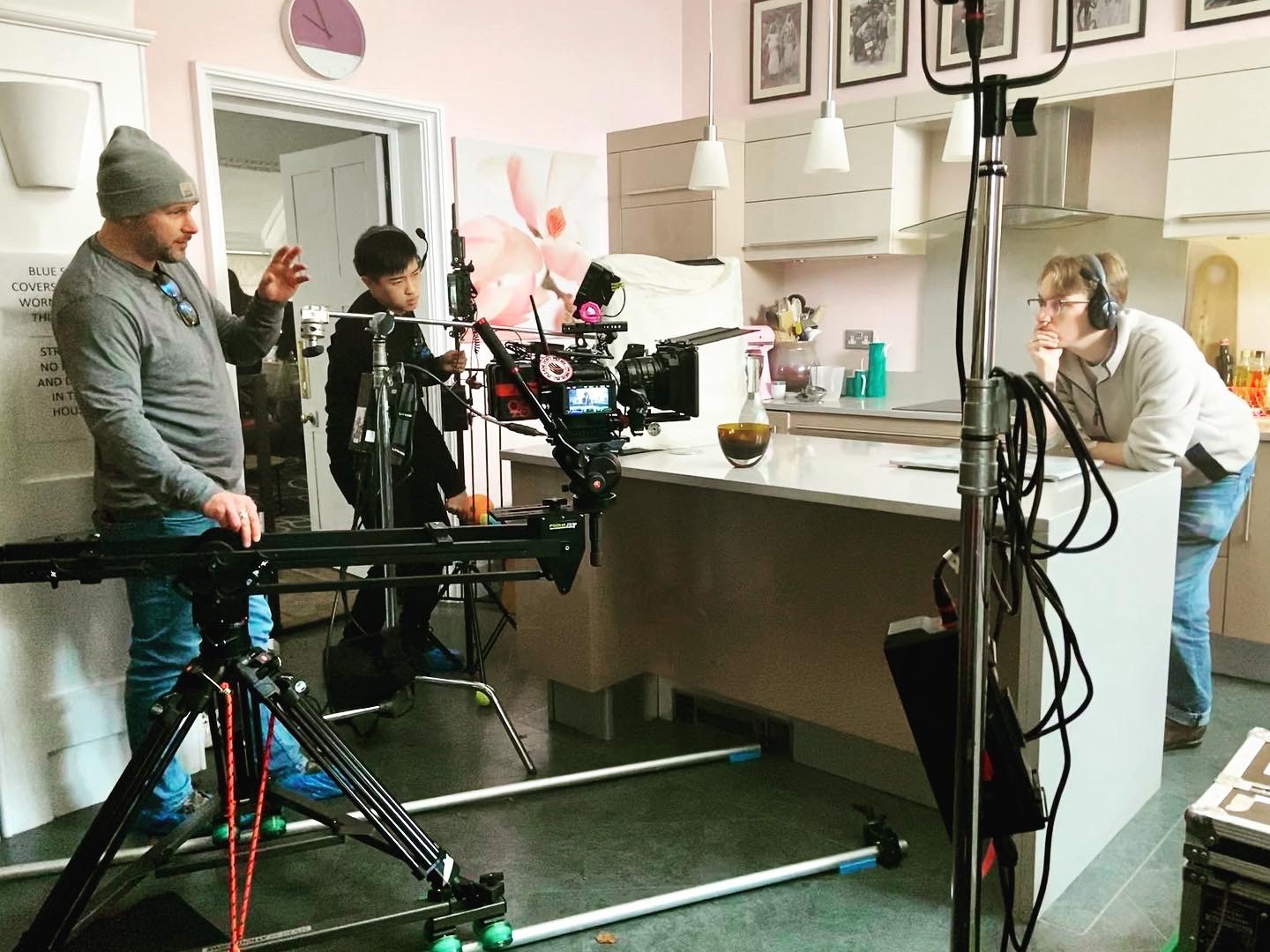 Camera on a slider with crew and lighting rigged on an interior location