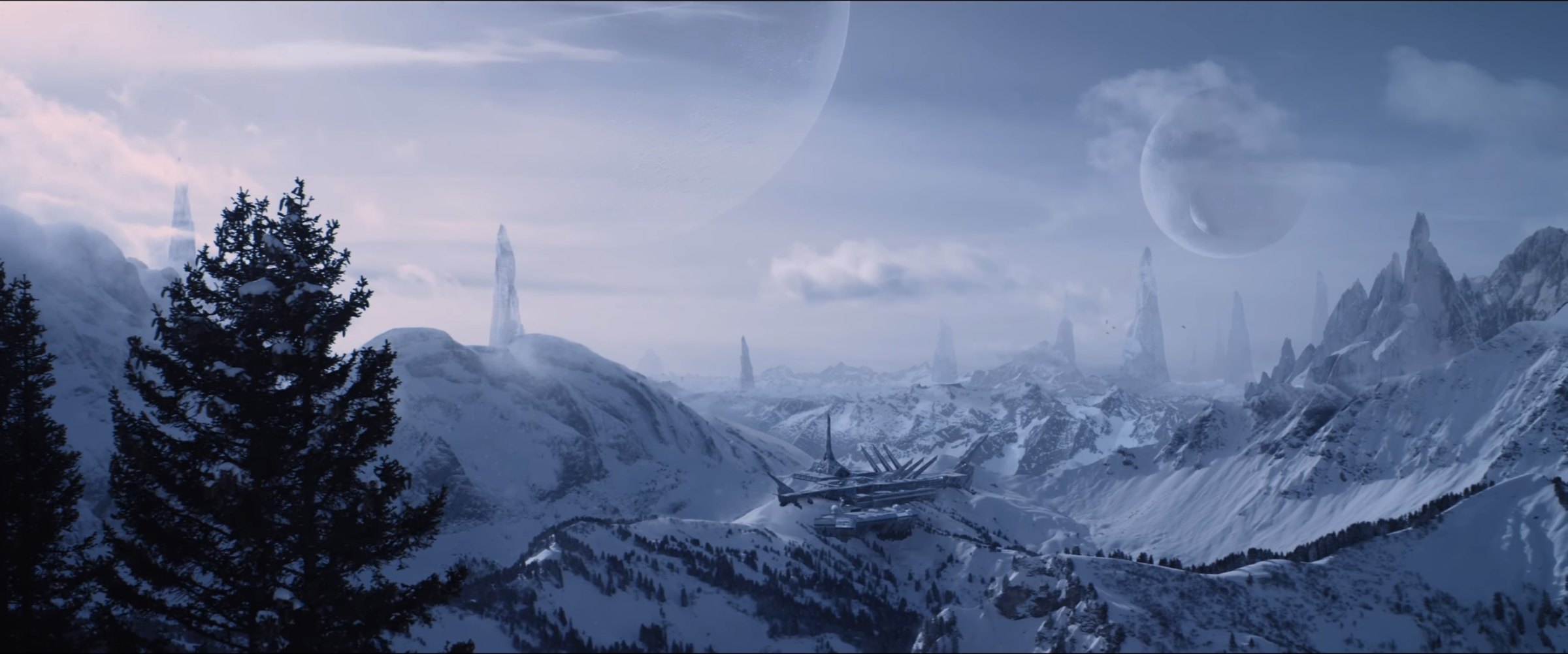 Production still — snowbound landscape under two moons