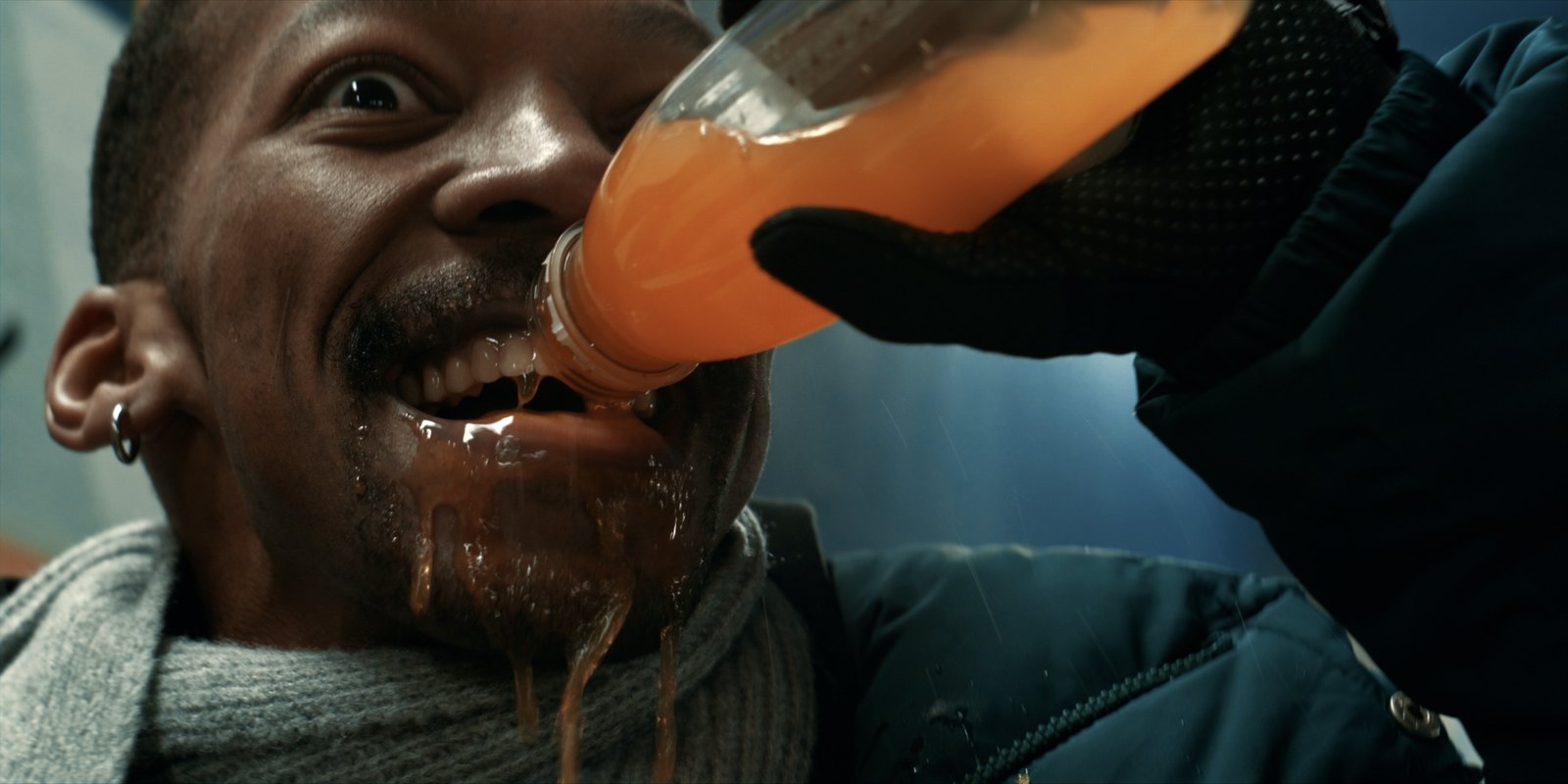 Production still — close-up, drink poured from a bottle